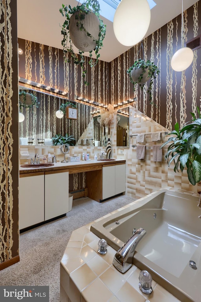 full bath with a bath, vanity, visible vents, and wallpapered walls