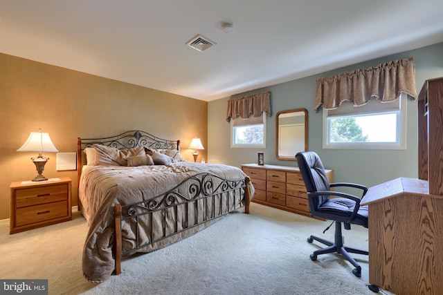 bedroom with light carpet and visible vents