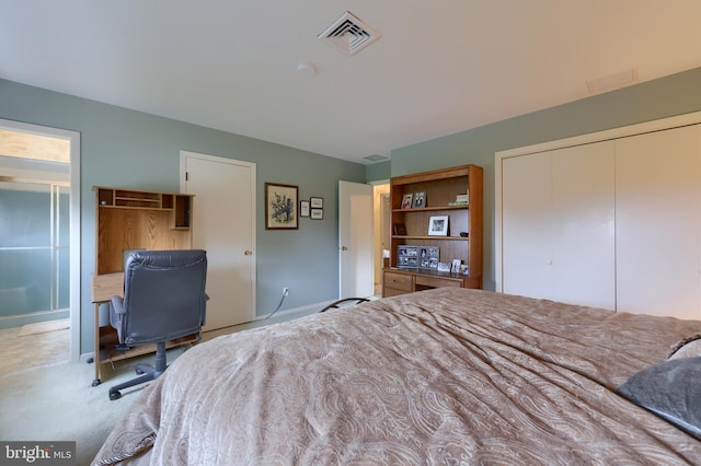 unfurnished bedroom with carpet floors, a closet, visible vents, and ensuite bath