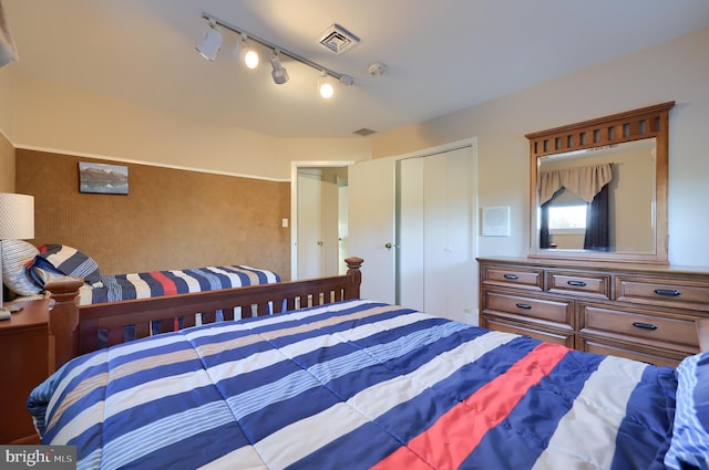 bedroom with a closet and visible vents