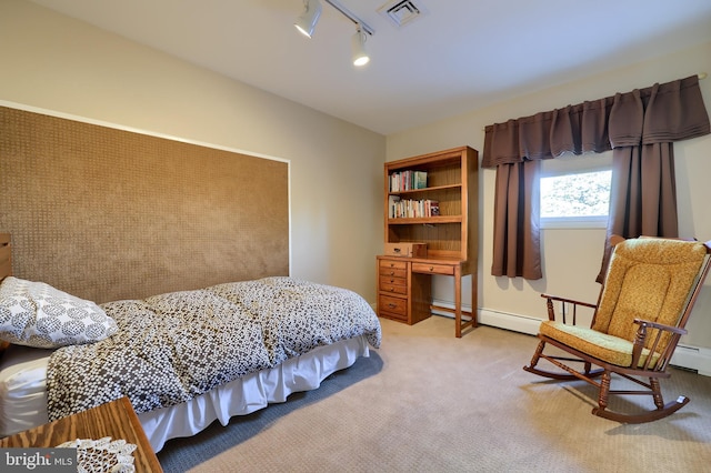 bedroom featuring light carpet, rail lighting, visible vents, and a baseboard heating unit