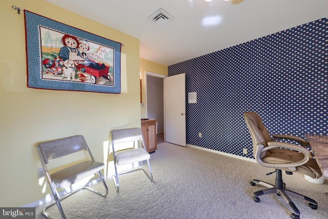 office area featuring wallpapered walls, carpet, visible vents, and baseboards