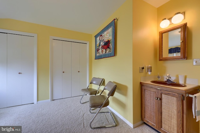 sitting room with baseboards and light colored carpet