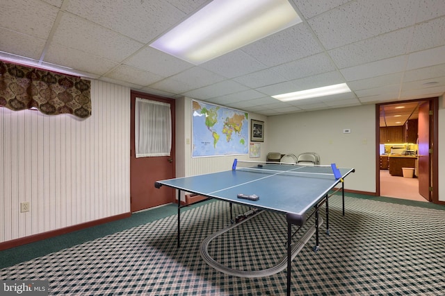 game room featuring carpet, a paneled ceiling, and baseboards