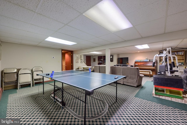 playroom with a drop ceiling and carpet