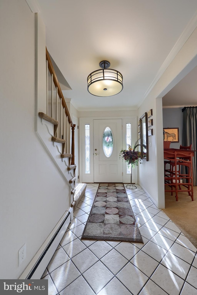 foyer entrance with ornamental molding, a baseboard radiator, light tile patterned flooring, and stairway