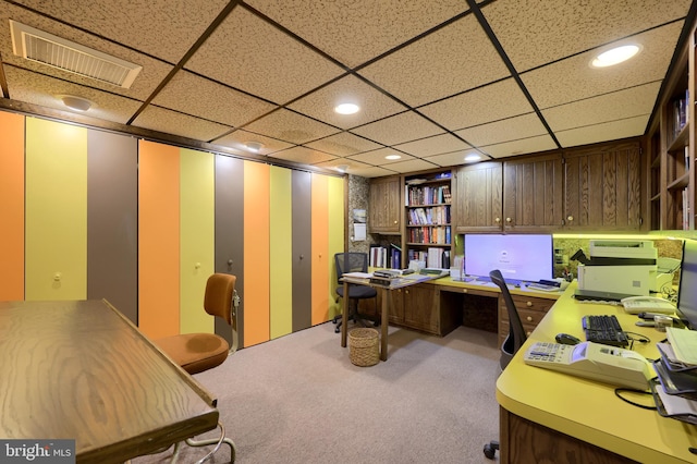 office area with carpet floors, recessed lighting, visible vents, and built in study area