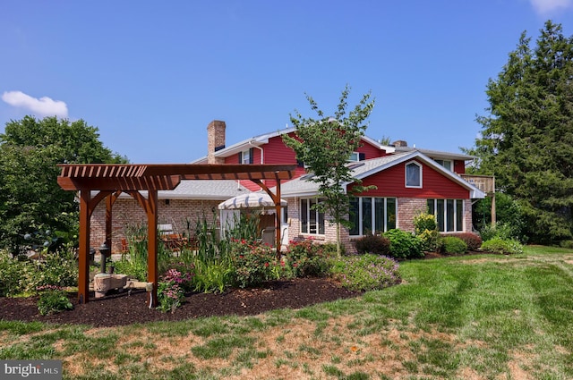 view of front of property featuring a chimney, a front lawn, a pergola, and brick siding