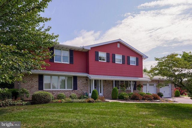 traditional home with driveway, a garage, a front lawn, and brick siding