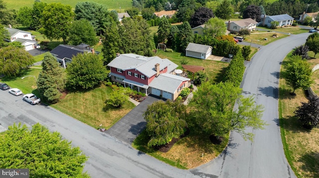 birds eye view of property with a residential view