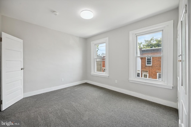 empty room featuring carpet floors and a healthy amount of sunlight