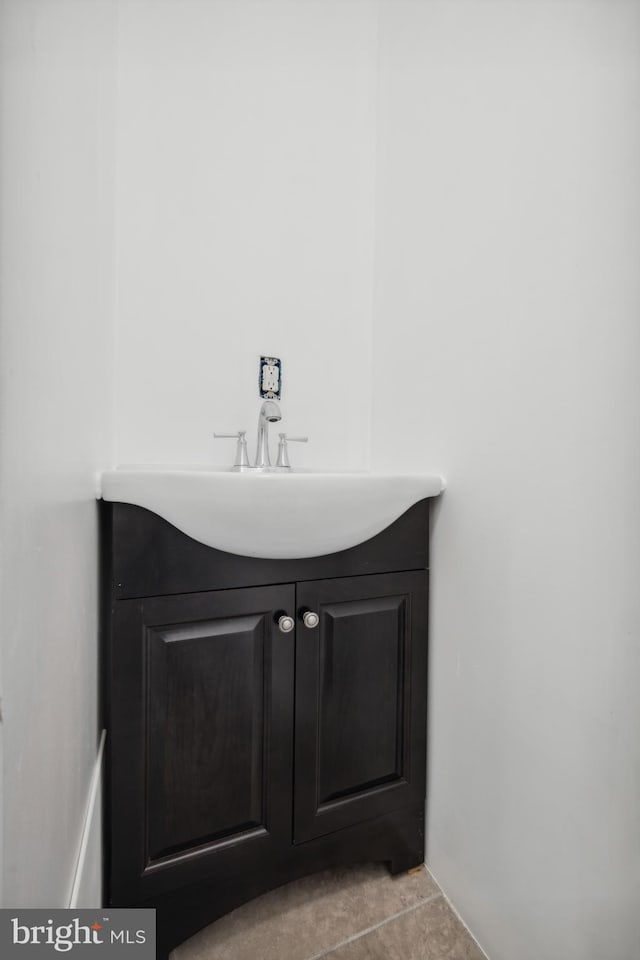 bathroom with tile patterned floors and vanity