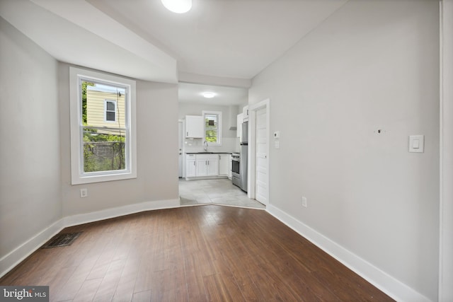 spare room with light tile patterned floors and sink