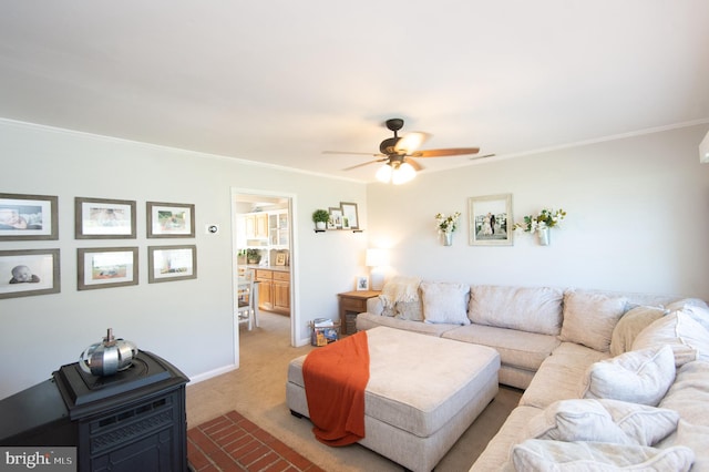 living room with light carpet, crown molding, and ceiling fan