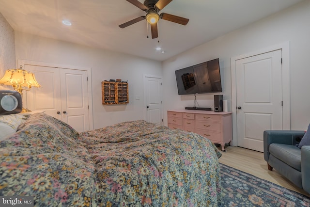 bedroom featuring light hardwood / wood-style floors, a closet, and ceiling fan