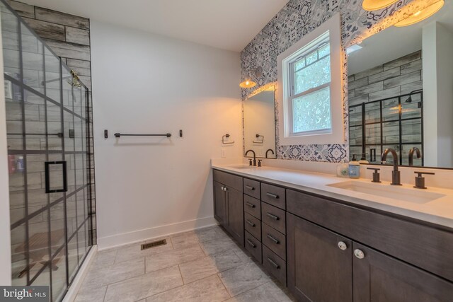 bathroom featuring vanity and a shower with door