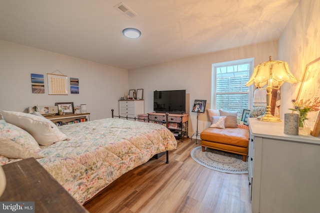 bedroom with hardwood / wood-style flooring