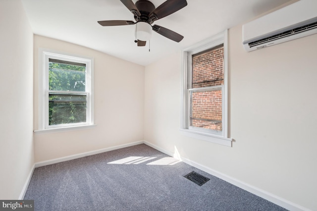 carpeted spare room with an AC wall unit