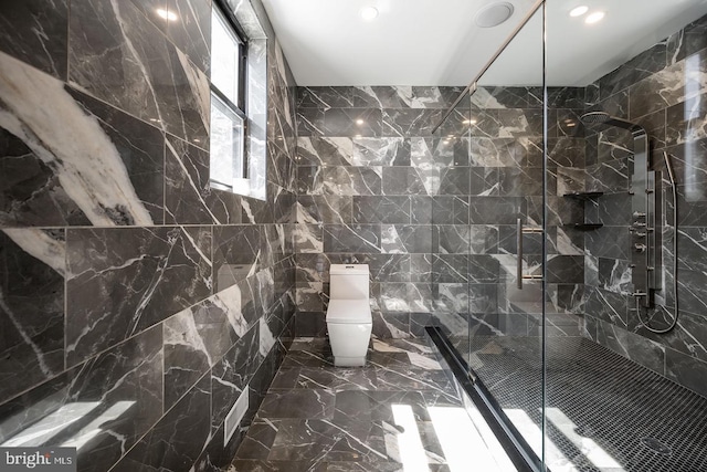 bathroom with a tile shower, tile walls, and toilet