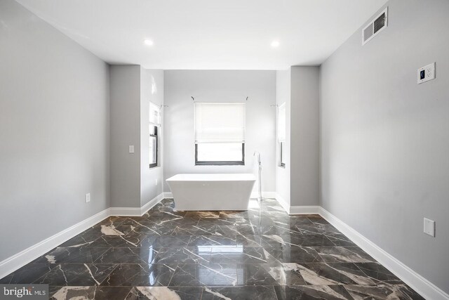 unfurnished room with dark tile patterned floors