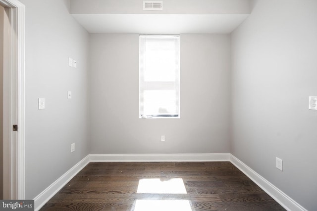 empty room with dark hardwood / wood-style flooring