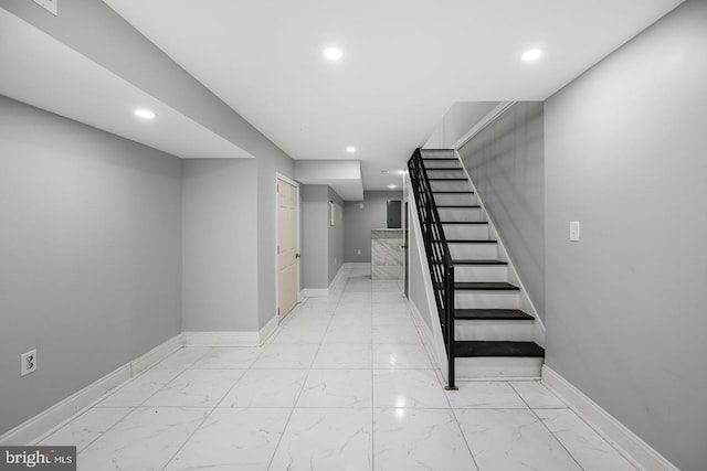 stairway with tile patterned floors