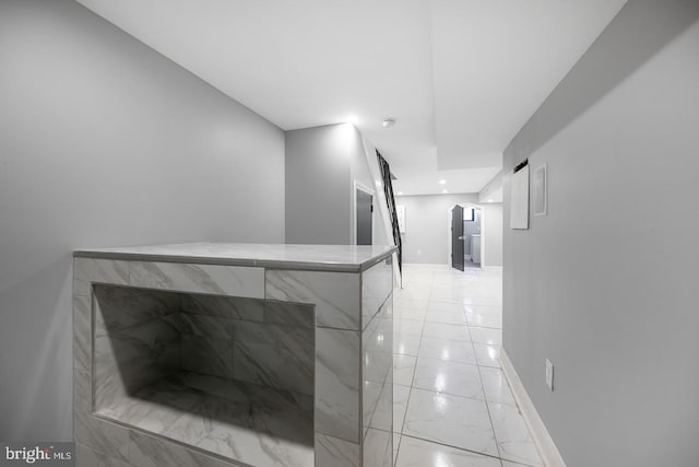 hall with light tile patterned floors