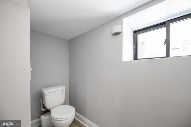 bathroom with toilet and tile patterned floors