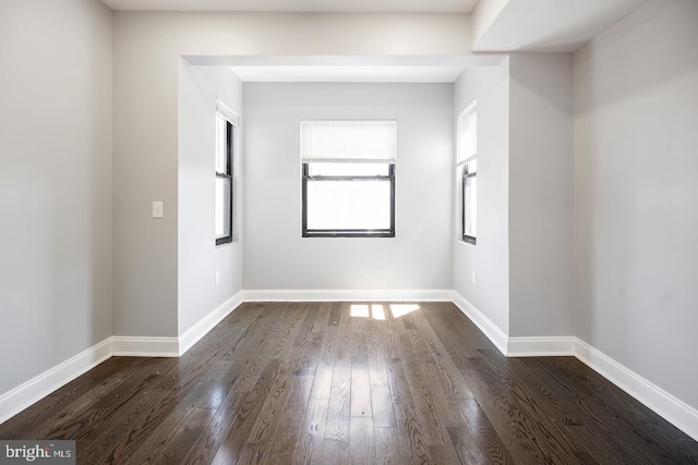 spare room with dark hardwood / wood-style flooring