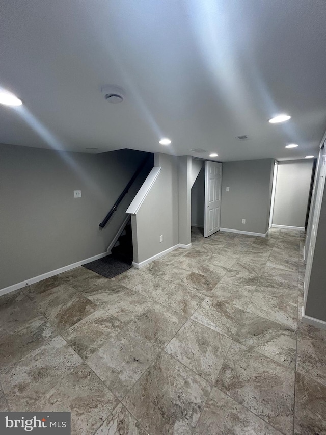 basement featuring light tile patterned flooring