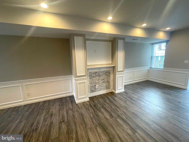 unfurnished living room with dark wood-type flooring