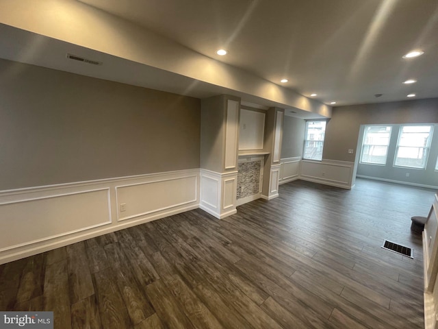 unfurnished living room with dark wood-type flooring