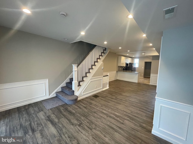 unfurnished living room featuring dark hardwood / wood-style floors