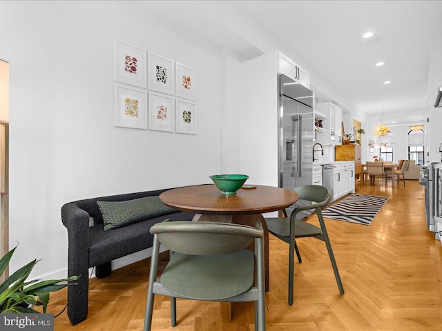 dining room featuring light parquet floors and sink