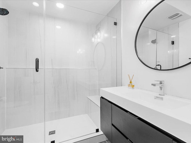 bathroom featuring vanity and an enclosed shower