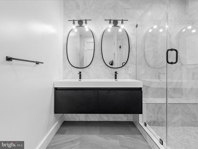 bathroom featuring tile patterned flooring, an enclosed shower, and double vanity