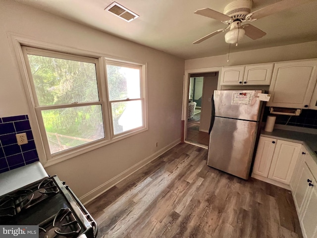 kitchen featuring ceiling fan, white cabinets, stainless steel fridge, gas range, and dark hardwood / wood-style flooring