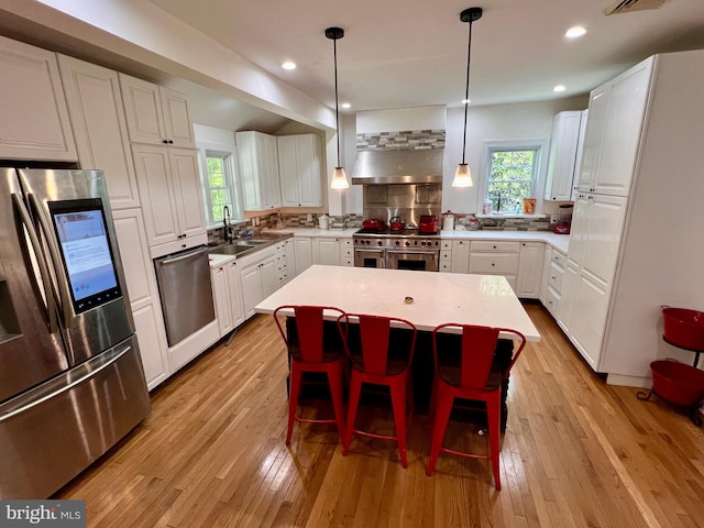 kitchen featuring white cabinetry, stainless steel appliances, and a sink