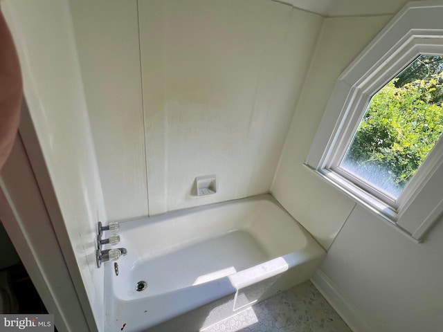 bathroom with a tub to relax in