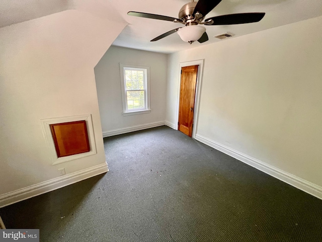 additional living space with a ceiling fan, baseboards, visible vents, and dark colored carpet