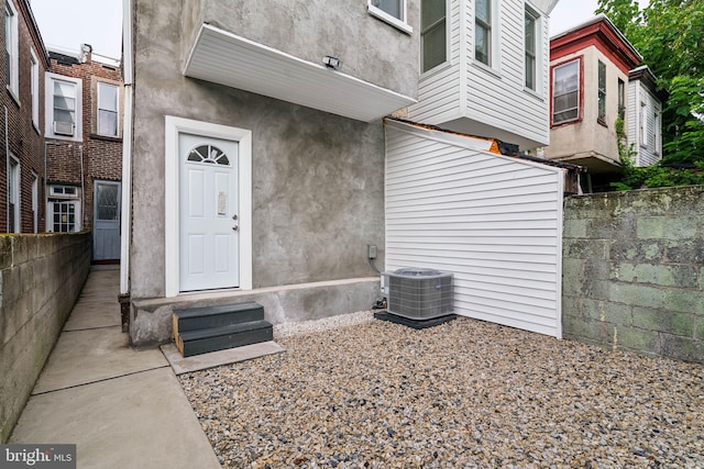 doorway to property featuring central AC unit