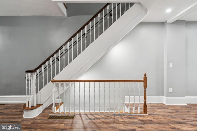 stairs featuring wood-type flooring