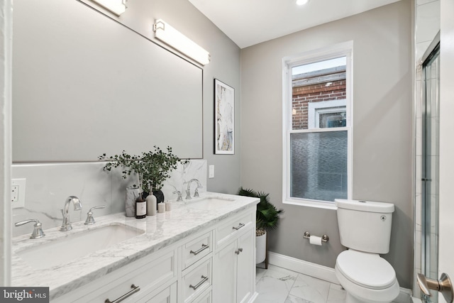 bathroom featuring vanity, a shower with door, and toilet