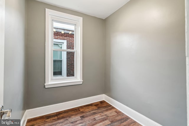 spare room featuring dark wood-type flooring