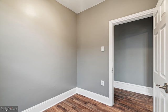 empty room with dark hardwood / wood-style flooring