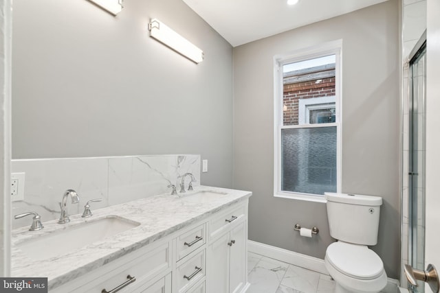 bathroom featuring vanity, plenty of natural light, a shower with door, and toilet