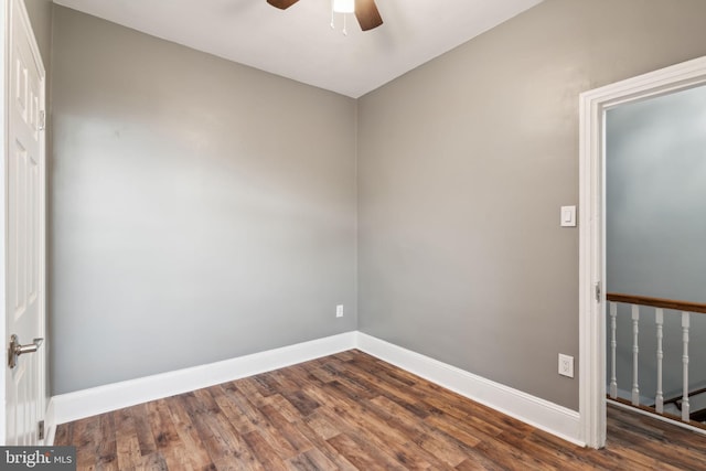 spare room with dark hardwood / wood-style flooring and ceiling fan