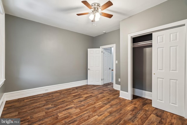 unfurnished bedroom featuring dark wood-type flooring, a closet, and ceiling fan