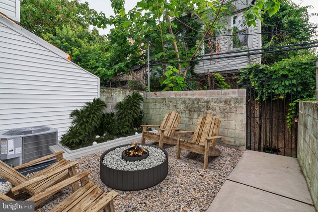 view of patio featuring a fire pit and central AC