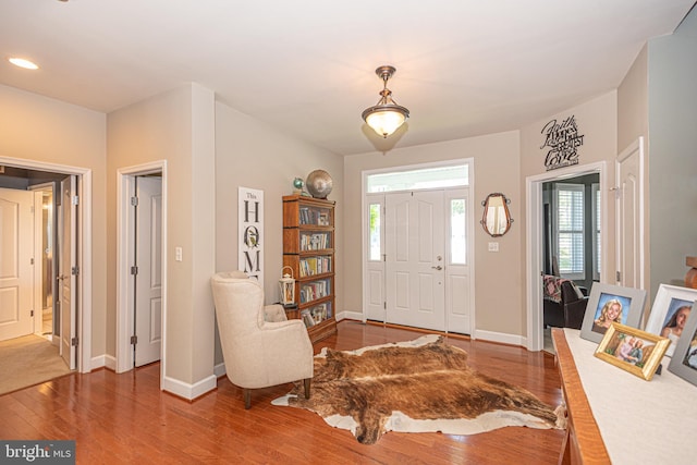 foyer entrance with dark wood-style flooring, recessed lighting, and baseboards